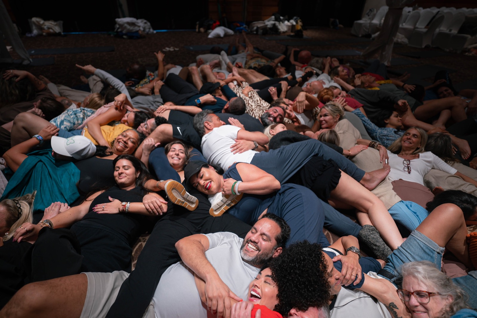 Guests laughing together on the floor at an Alchemize gathering